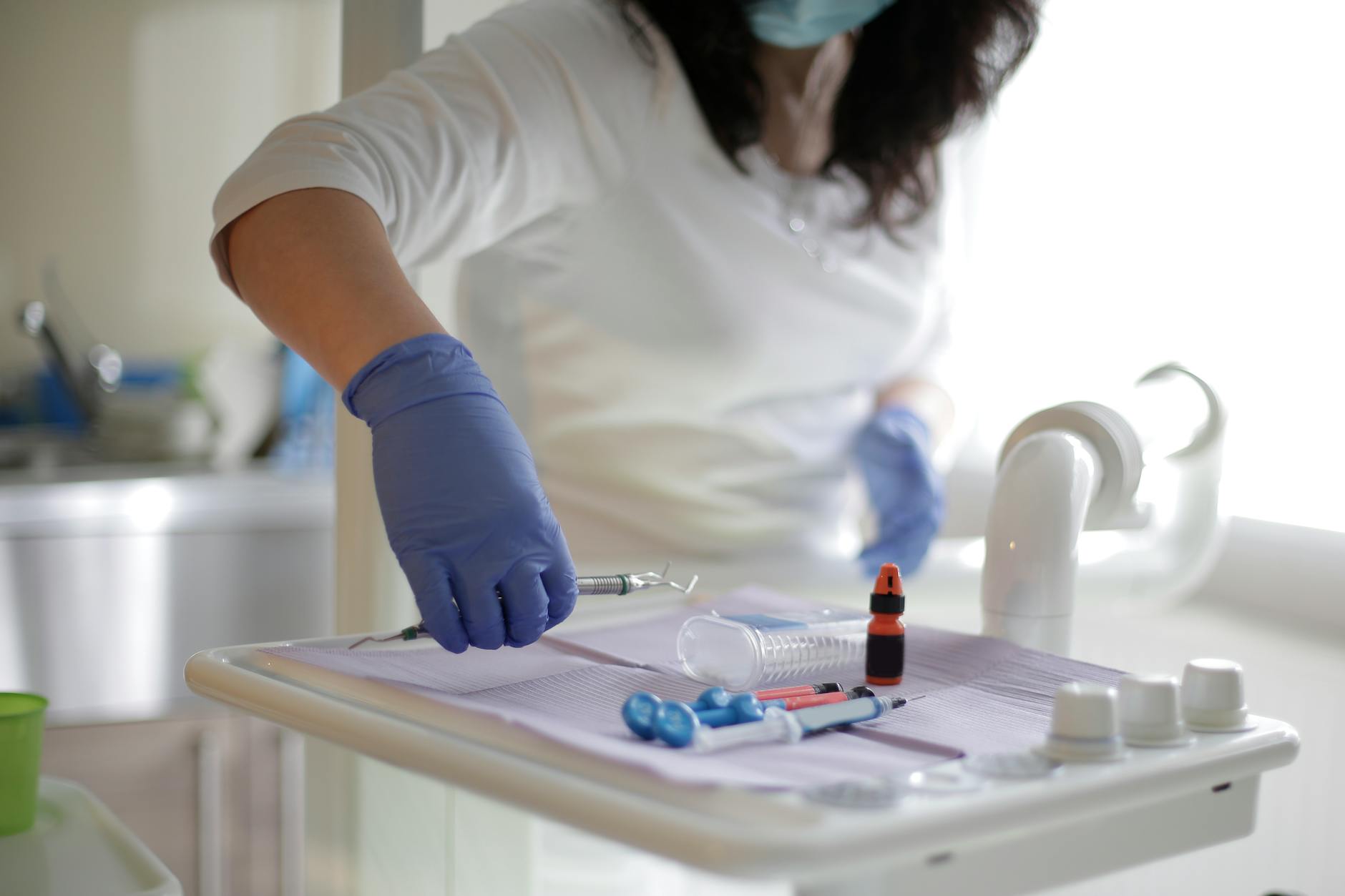 anonymous female dentist in dental cabinet