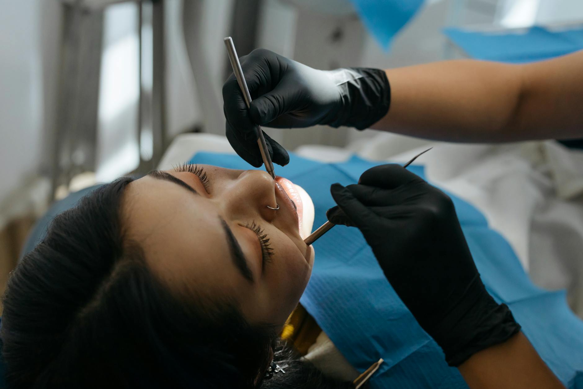 close up photo of dentist examining patient s teeth